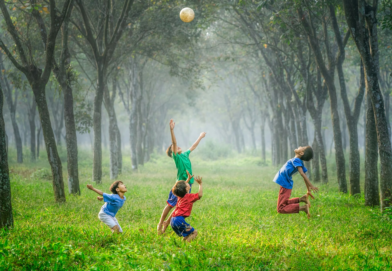 Kids playing football on grass