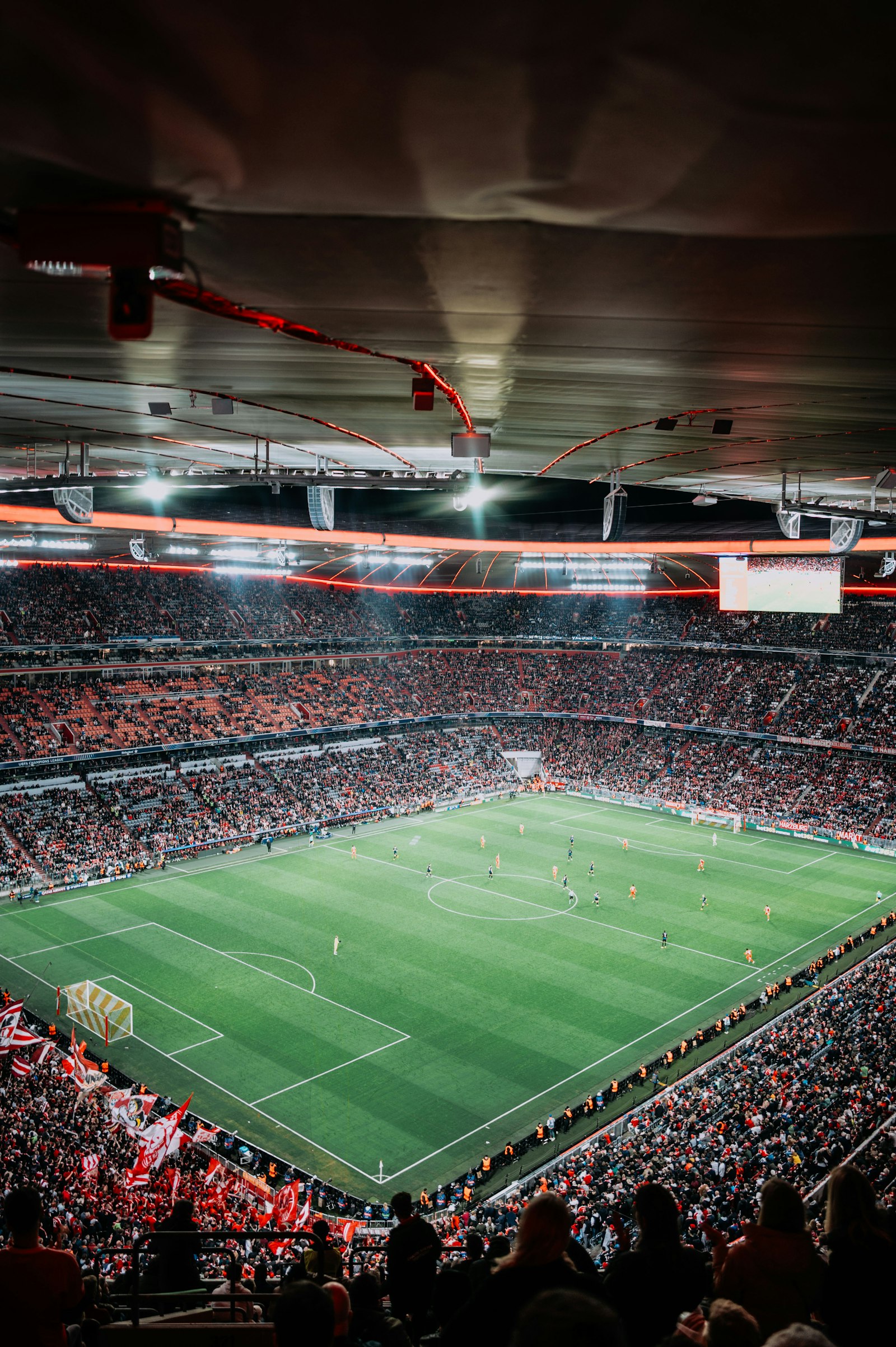 Soccer match in packed stadium at night