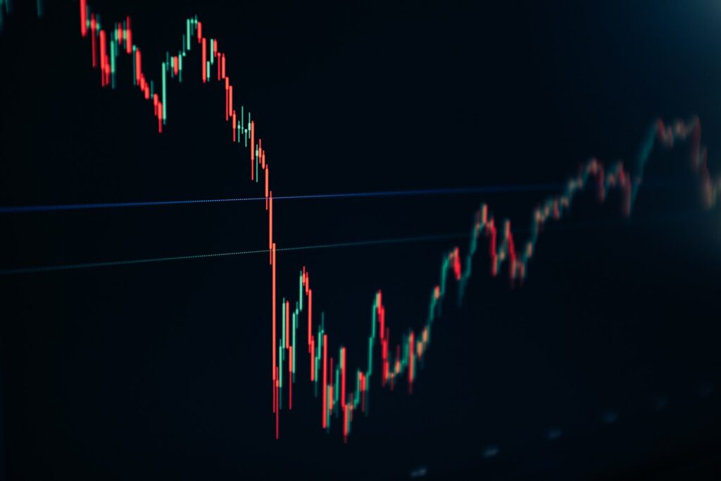 Candlestick stock chart on a dark screen, representative image