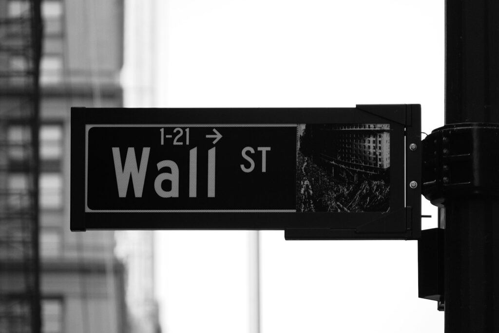 Grayscale photo of Wall St. signage, representative image
