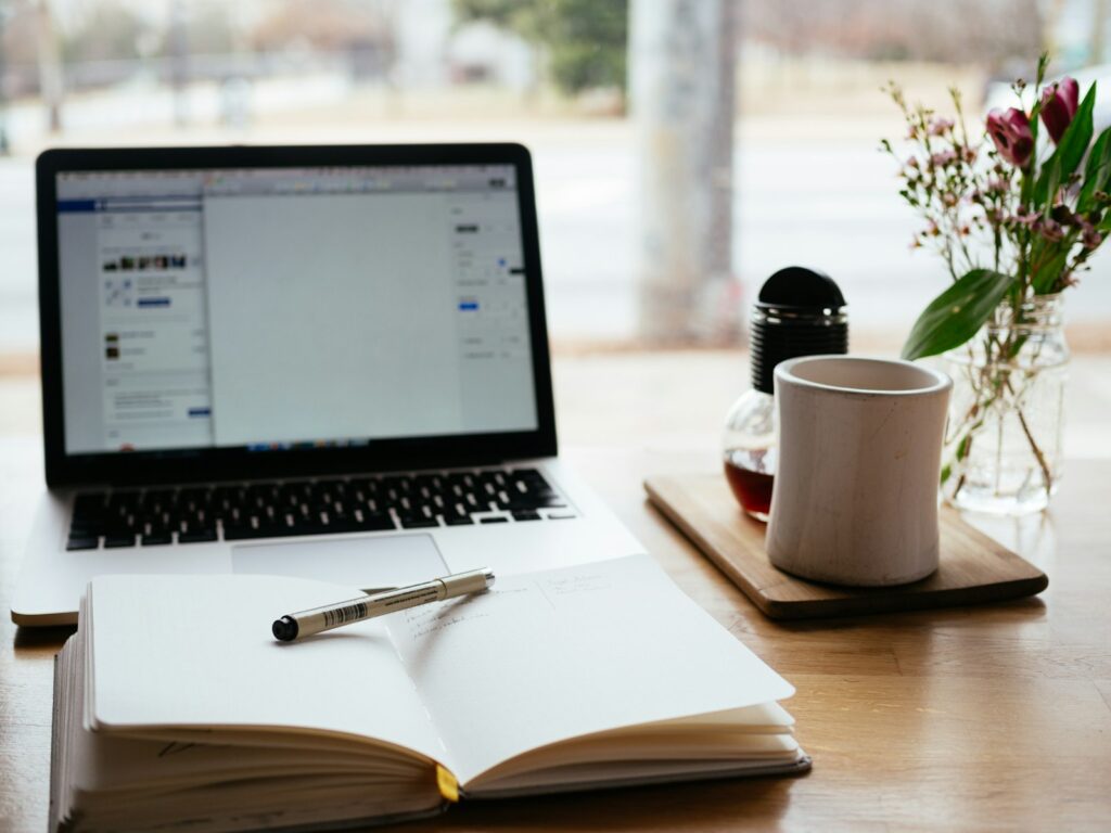 Laptop near an open book, representative image