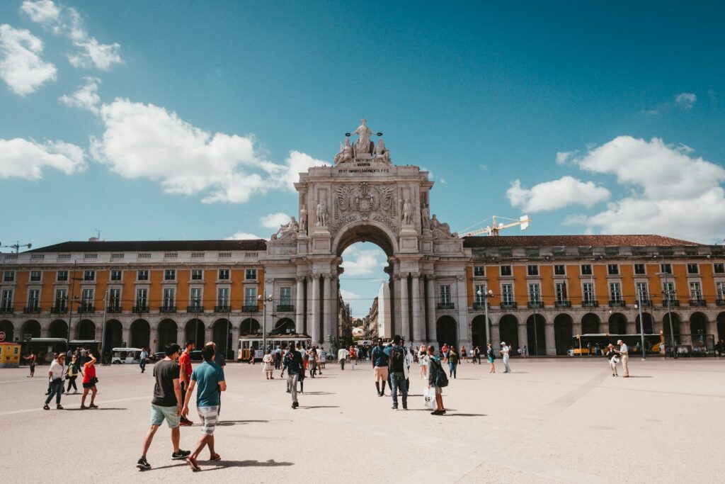 People gathered on a street in Lisbon, representative image