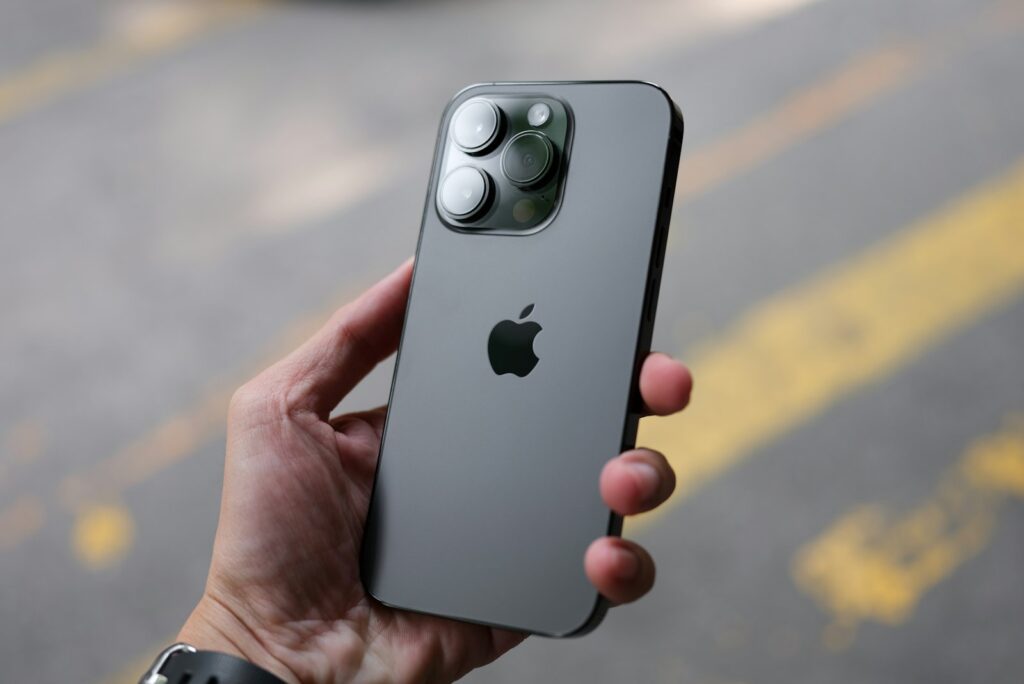 Person holding an iPhone, representative image