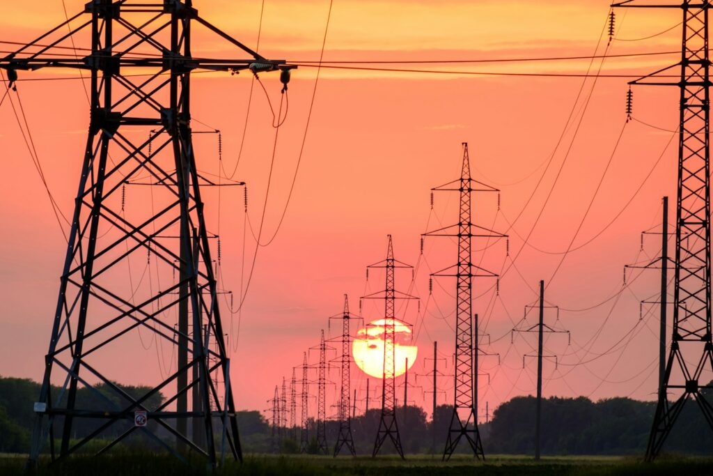 Silhouette of an electric post at sunset, representative image