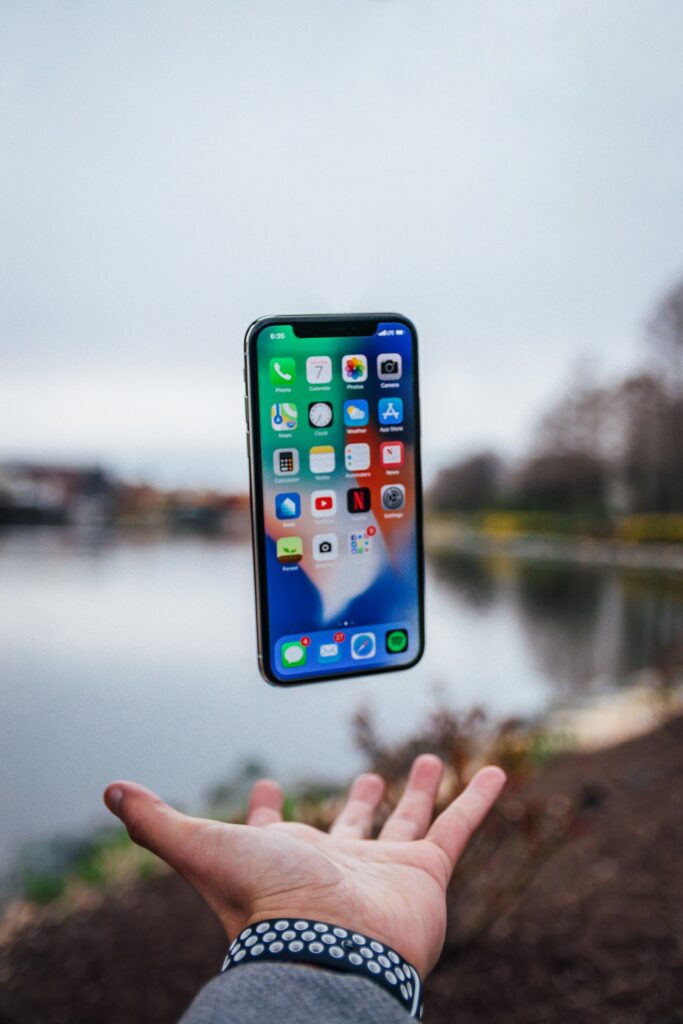 Smartphone floating over an open palm, representative image