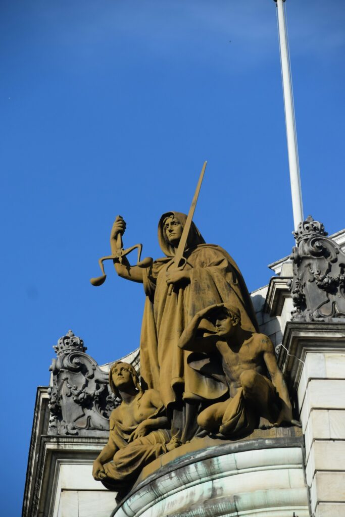 Statue of justice against blue sky, representative image
