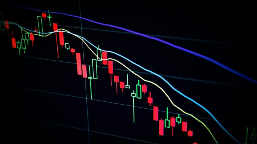 Stock market candlestick chart on a dark screen, representative image