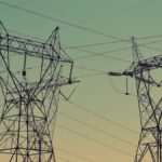 Transmission towers under an evening sky, representative image