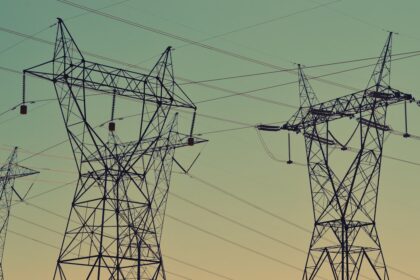 Transmission towers under an evening sky, representative image