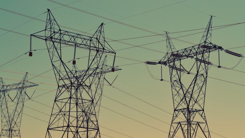 Transmission towers under an evening sky, representative image