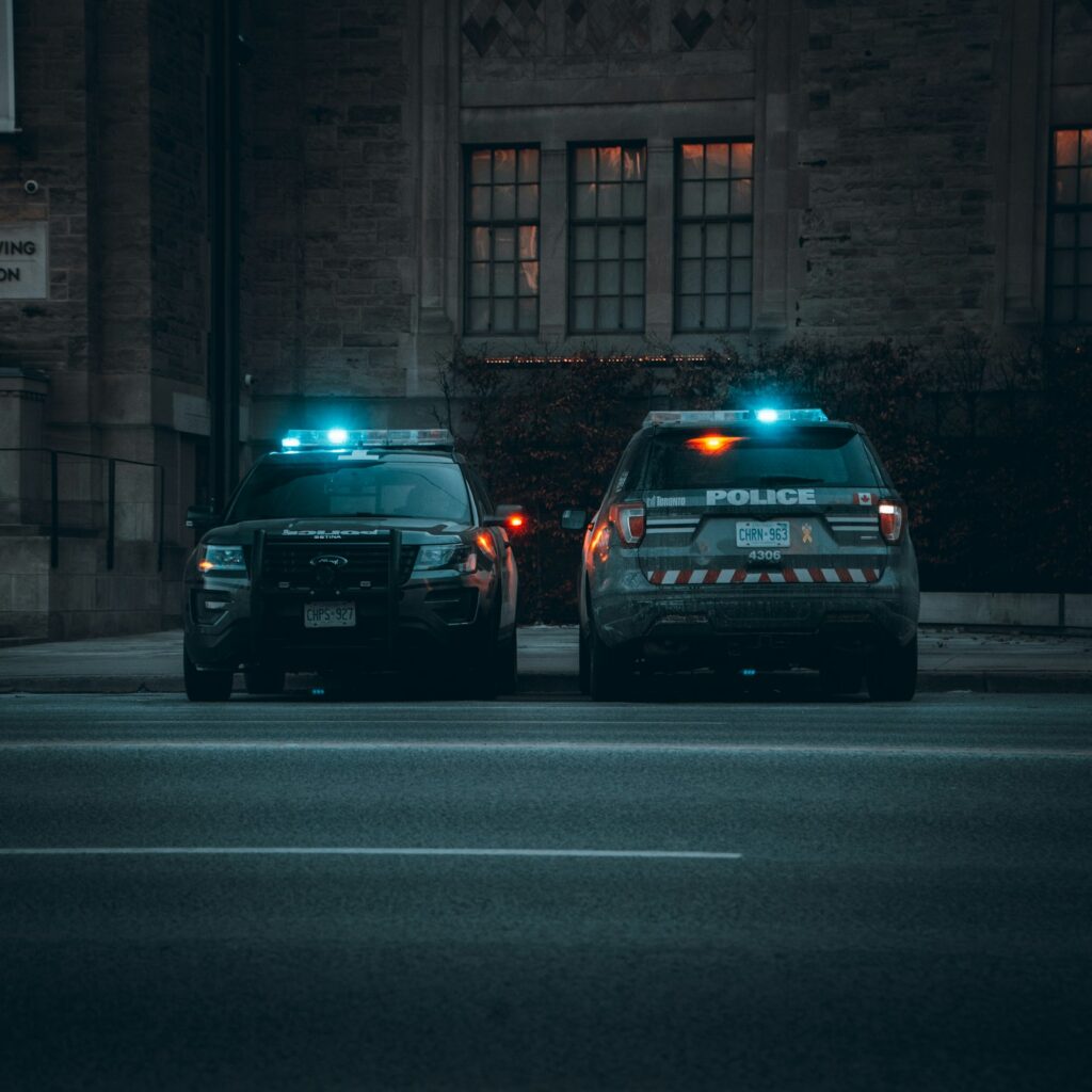 Two police cars parked on the side of the road, representative image