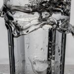 Glass of water with a splash, representing overhydration risk