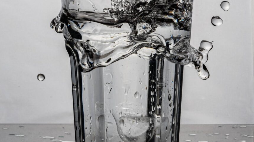 Glass of water with a splash, representing overhydration risk