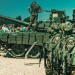 Soldiers train with an armored vehicle in a field exercise