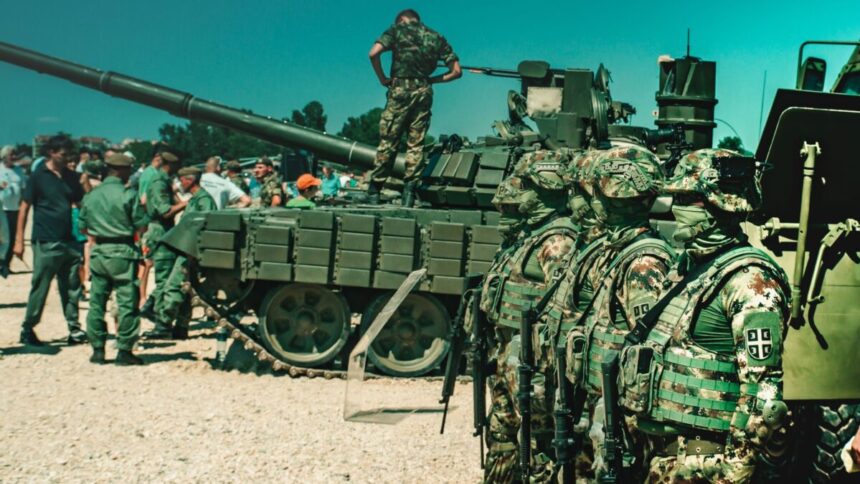 Soldiers train with an armored vehicle in a field exercise