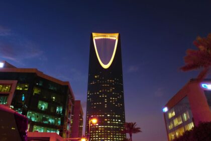 Riyadh skyline at twilight showing the illuminated Kingdom Centre tower, Saudi Arabia