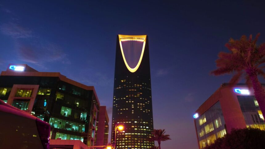 Riyadh skyline at twilight showing the illuminated Kingdom Centre tower, Saudi Arabia