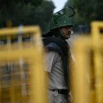 Delhi Police personnel stand guard ahead of the Cockroach Janata Party protest in New Delhi