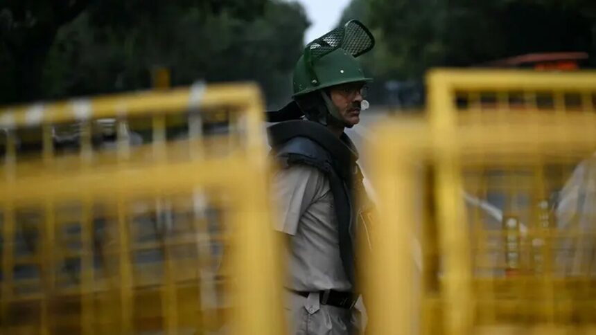 Delhi Police personnel stand guard ahead of the Cockroach Janata Party protest in New Delhi