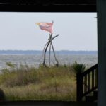 Flag flutters outside a home as Hurricane Isaias nears Dauphin Island, Alabama