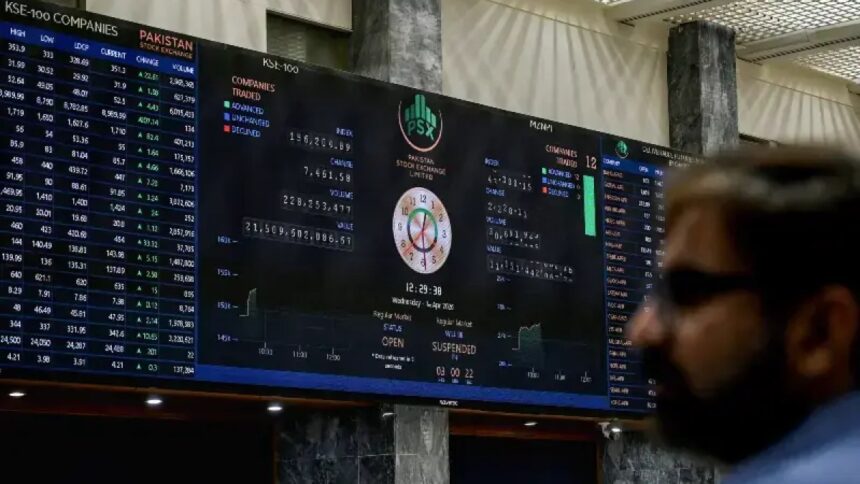 A stock broker watches share prices on a digital board at the Pakistan Stock Exchange in Karachi
