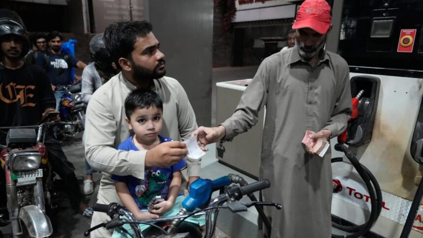 A motorcyclist refuels at a subsidized fuel station in Lahore as Pakistan petrol price nears Rs400 per litre